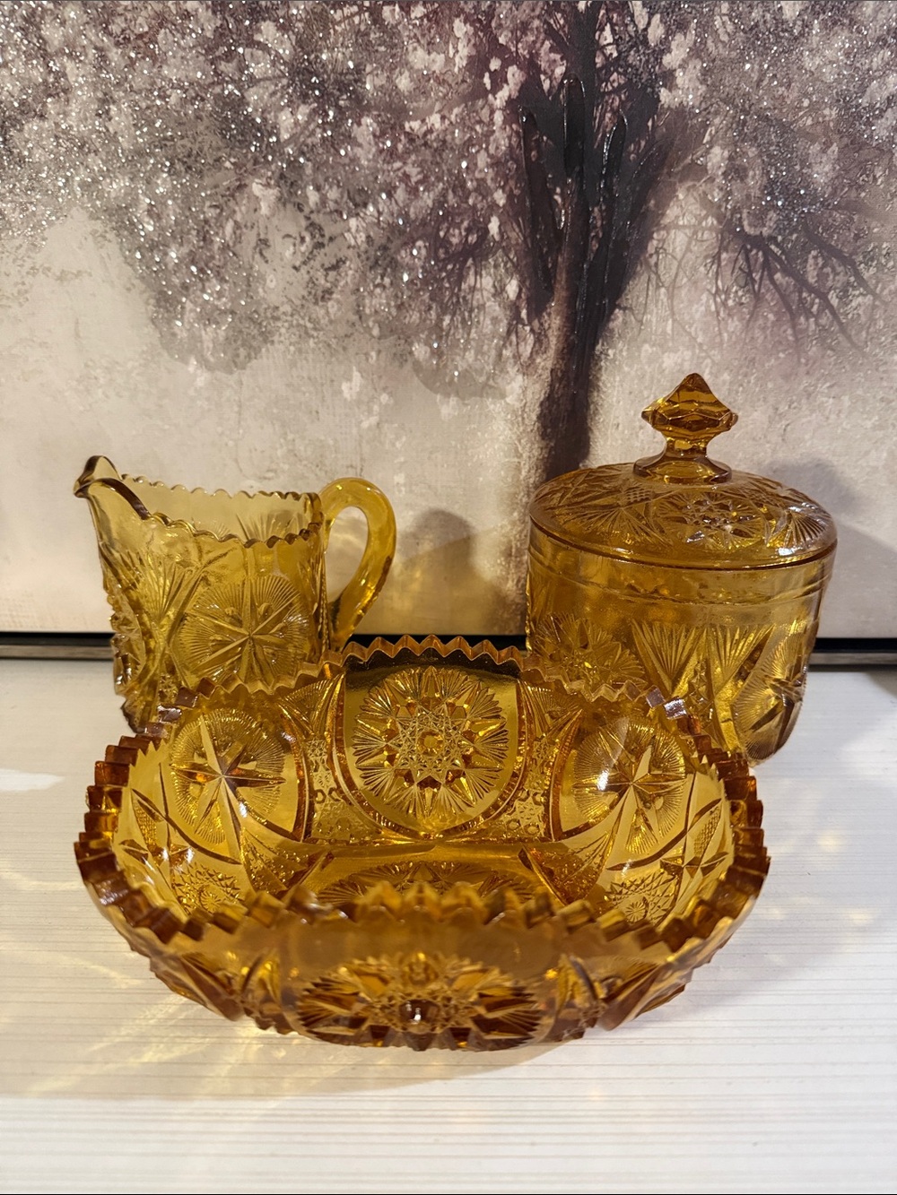 vintage amber glassware includes a creamer,  bowl with a lid, and a serving dish